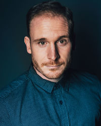 Portrait of man against blue background