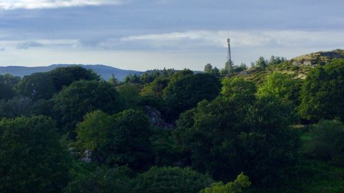 Scenic view of mountains against cloudy sky