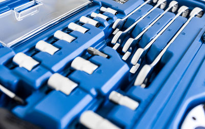 Close-up of metal tools in a blue plastic case. wrenches, bits and instruments for repair