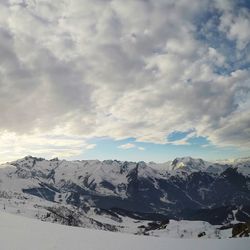 Scenic view of snow covered mountains against sky