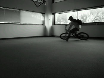 Man cycling in empty room