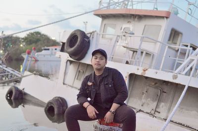 Young man sitting on boat