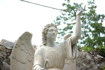 Low angle view of statue against sky