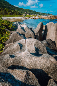 Scenic view of rocks on beach against sky