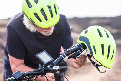 Midsection of man holding bicycle