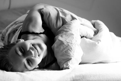 Close-up of baby sleeping on bed at home