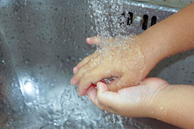 Close-up of woman hand in water