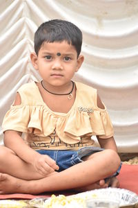 Portrait of cute boy sitting