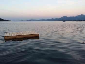 Pier on lake against sky