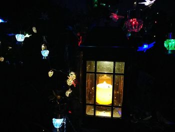 Low angle view of illuminated lanterns hanging from ceiling