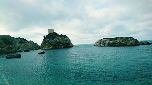 Scenic view of sea against cloudy sky