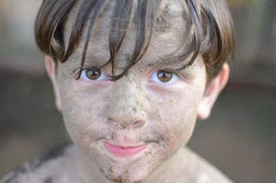 Close-up portrait of muddy boy