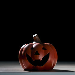 Close-up of pumpkin on table against black background