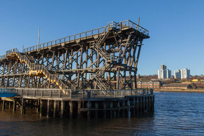 Built structure on sea against clear sky