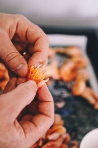 Close-up of hand holding orange