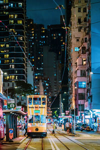 Illuminated city street and buildings at night