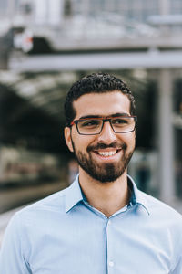 Young man standing at railroad station platform