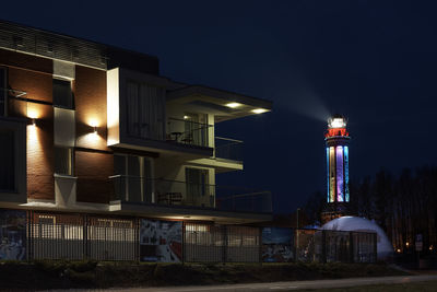 Illuminated built structure against sky at night