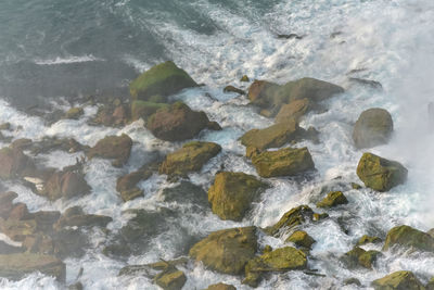 High angle view of rocks at sea shore