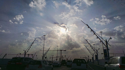 Cars on street in city against sky