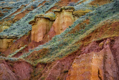 Full frame shot of  colourful rock formation with grass