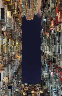 Directly below shot of building against sky at night