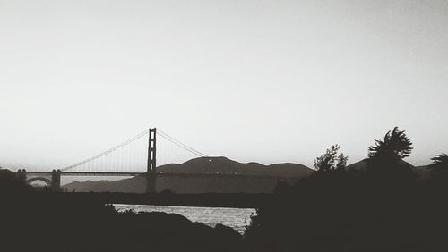 Bridge over river against clear sky