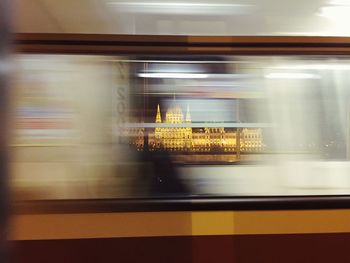 Blurred motion of subway train against illuminated hungarian parliament building
