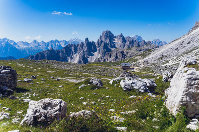 Scenic view of snowcapped mountains against blue sky