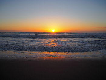 Scenic view of sea against clear sky during sunset