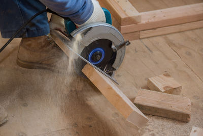 High angle view of man working on wooden table