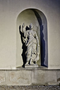 Statue of buddha against wall in building