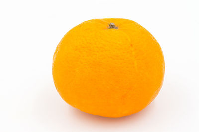 Close-up of orange slice against white background