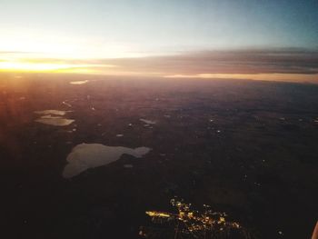Aerial view of city against sky during sunset