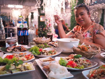 Midsection of woman having food on table