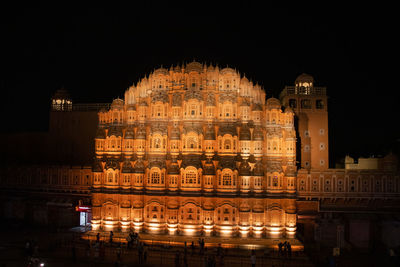 Illuminated building against sky at night