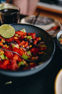 Close-up of chopped fruits in bowl on table