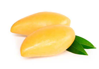 Close-up of lemon slice over white background