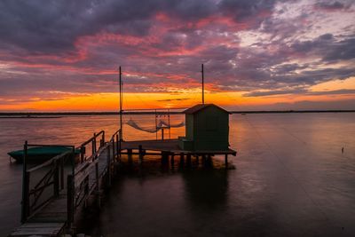 Scenic view of sea against dramatic sky during sunset