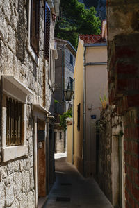 Narrow alley amidst buildings at night