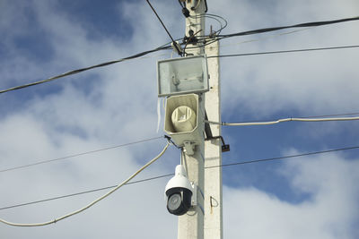 Low angle view of telephone pole against sky