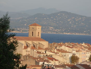 Townscape by sea against sky