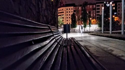 Surface level of illuminated city against sky at night