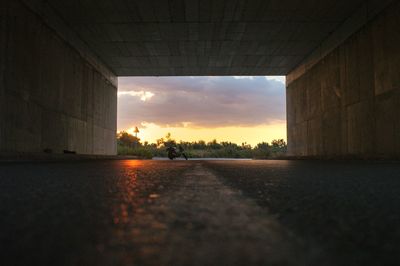 Surface level shot of road against sky during sunset