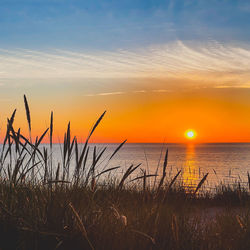 Scenic view of sea against romantic sky at sunset