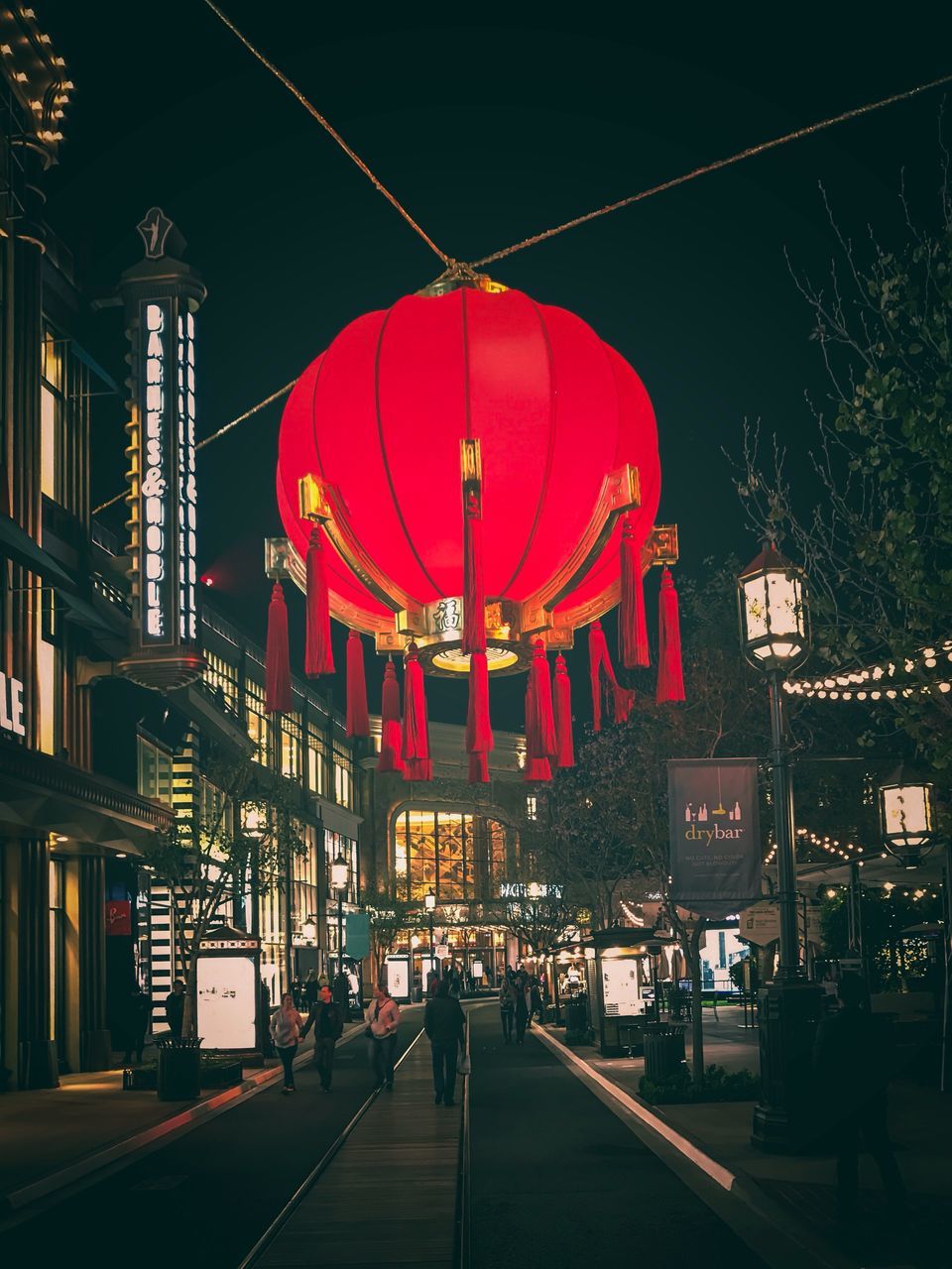 built structure, architecture, night, building exterior, illuminated, large group of people, city, travel destinations, red, real people, outdoors, hanging, clear sky, dome, women, sky, men, tree, crowd, people