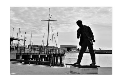 Rear view of man looking at harbor