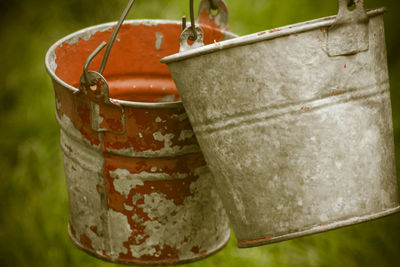 Close-up of buckets hanging outdoors