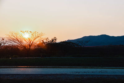 Scenic view of field against sky during sunset