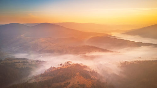 Scenic view of mountains against sky during sunset